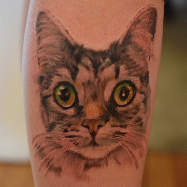 cat tattoo green eyes